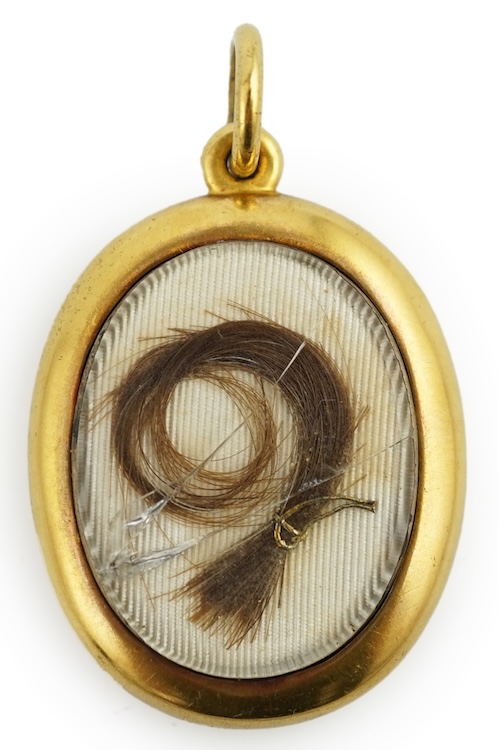 A yellow metal locket containing a lock of Napoleon I hair